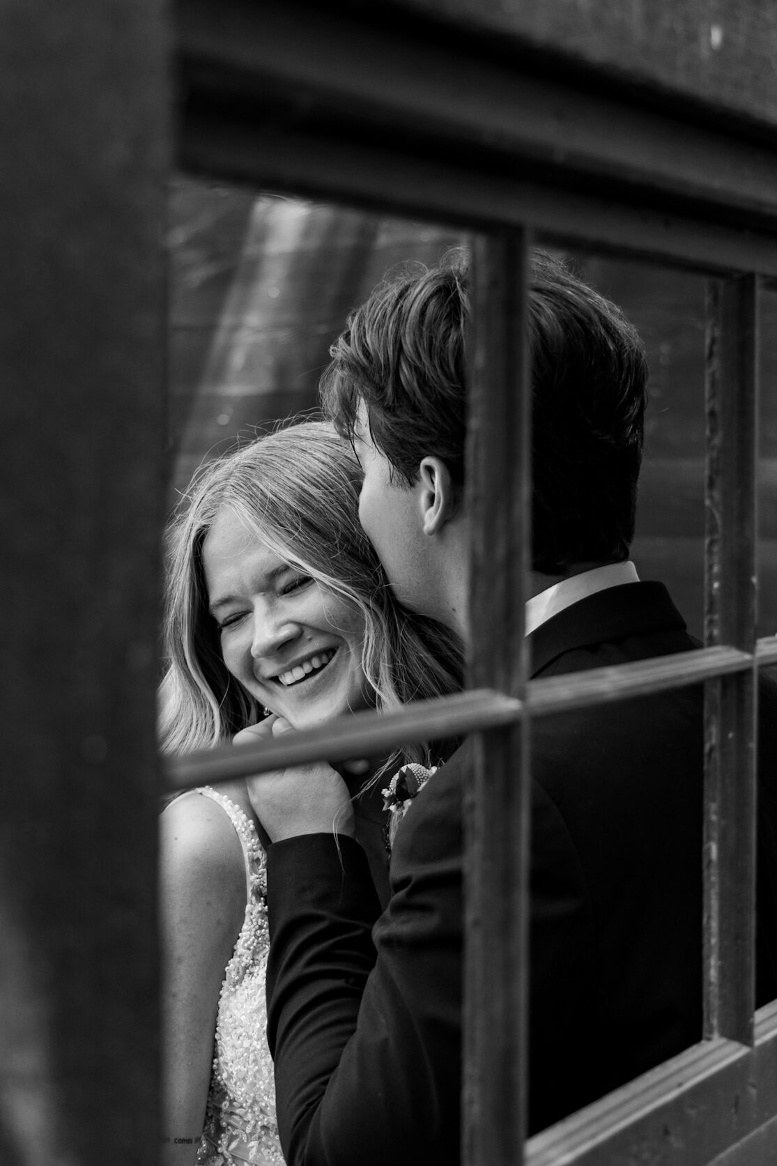 Bride and Groom laughing at Ivory North Co in black wooden structure sweet intimate moment 