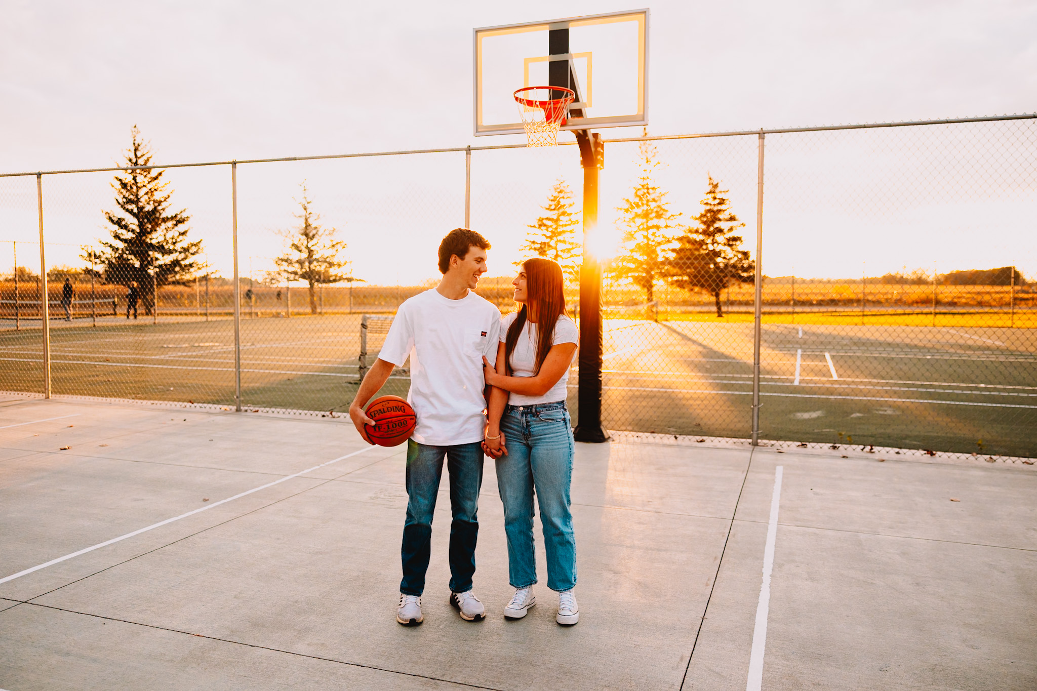 Couples session playing basketball at golden hour in Minnesota